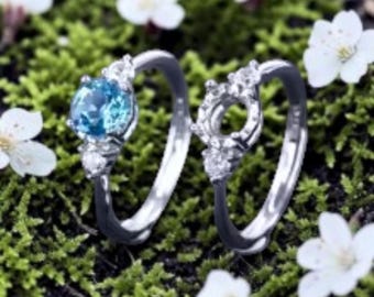 Conjunto de anillo de compromiso con halo de topacio azul y alianza nupcial de plata de ley.