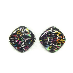 May include: A pair of black diamond-shaped earrings with a colorful abstract pattern. The earrings have a silver-colored metal loop at the top.