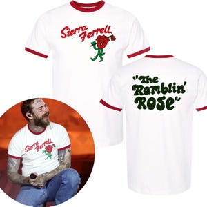 May include: White ringer t-shirt with red trim featuring the text "Sierra Ferrell" in red script and a green and red rose graphic. The back of the shirt displays the text "The Ramblin' ROSE" in green.