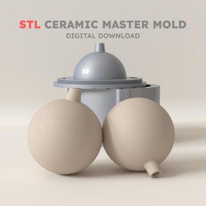 May include: STL CERAMIC MASTER MOLD DIGITAL DOWNLOAD text appears above a gray cylindrical mold with a dome top and two beige spherical ceramic objects with small protruding necks positioned in the foreground.