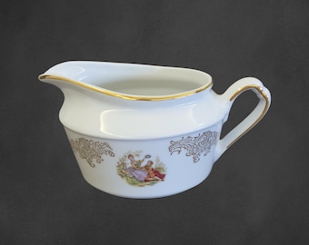 May include: White porcelain creamer with a gold rim and a gold floral design. The creamer features a painted scene of two people in a garden.