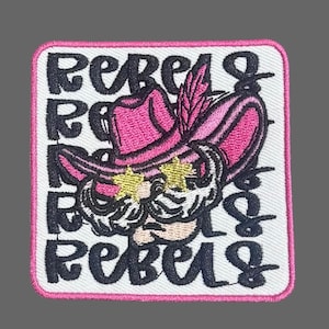 May include: White embroidered patch with a pink cowboy hat with a feather, a white beard, and gold star sunglasses. The text "Rebels" is repeated around the image.