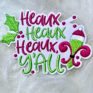 May include: Green and pink embroidered iron-on patch with the text "Heaux Heaux Heaux Y'all".
