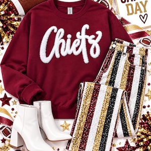 May include: A maroon crewneck sweatshirt with white chenille lettering that reads Chiefs, paired with sequined pants featuring vertical stripes in gold, white, maroon, and black, and a pair of white pointed-toe ankle boots with block heels.