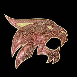 May include: A pink and gold sequined wildcat head applique. The wildcat is facing right and has a fierce expression.