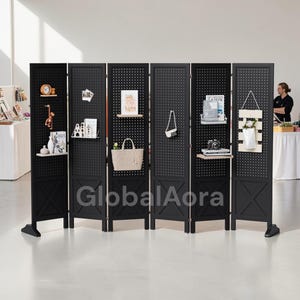 May include: A black, six-panel room divider with a perforated design. Each panel has small shelves displaying decorative items like a clock, figurines, and a camera. The text "GlobalAora" is visible on the divider.
