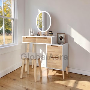 May include: A white and wood-effect dressing table set with a round, illuminated mirror. The set includes a stool, two drawers, and a cabinet. The vanity is near a window, and the text "Global Aora" is visible on the cabinet.