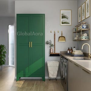 May include: A tall, dark green storage cabinet with two doors and vertical gold handles, featuring the text GlobalAora. The cabinet stands on four short legs and has a smooth, matte finish, providing a clean and functional storage solution.