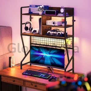 May include: A wooden desk with a black metal frame and shelves, featuring a computer monitor, keyboard, and gaming accessories. The shelves display a projector, speakers, and decorative items. The desk is illuminated with warm lighting.