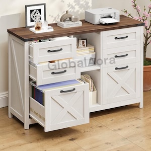May include: A white and brown wooden office cabinet with drawers and an open shelf. The cabinet has black handles and an X-shaped design on the drawer fronts. A printer and decorative items sit on the top surface.