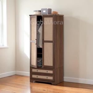 May include: A dark brown wooden wardrobe with two doors and two drawers. The doors have woven cane panels. The wardrobe is partially open, revealing hanging clothes and folded items. A hat and boxes sit on top.