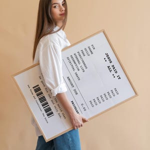May include: A white framed print with a receipt-style design that reads "Jesus Paid It All" with a list of items and the price "Priceless".