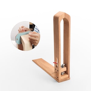 May include: A wooden leather stitching pony with a clamp and a red lever. The pony is used to hold leather while stitching.