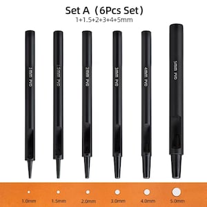 May include: Set of six black leather hole punch tools with different sizes: 1mm, 1.5mm, 2mm, 3mm, 4mm, and 5mm. The tools are labeled with their size and "PVD".