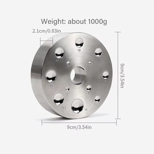 May include: A silver metal ring with 10 holes of different sizes, labeled with numbers. The ring is 9 cm in diameter and weighs about 1000 grams.