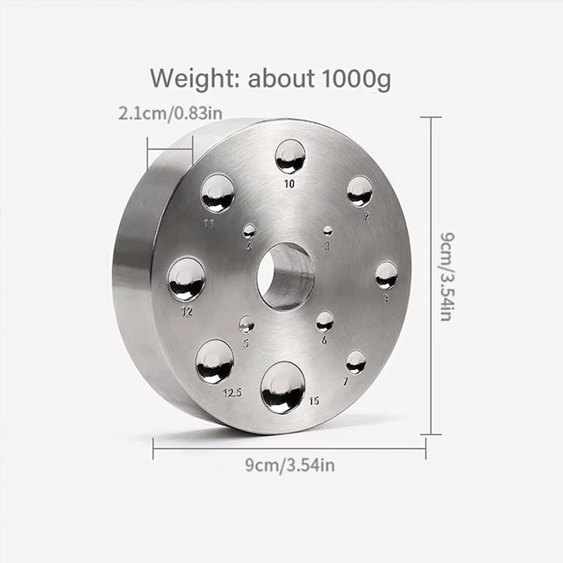May include: A silver metal ring with 10 holes of different sizes, labeled with numbers. The ring is 9 cm in diameter and weighs about 1000 grams.