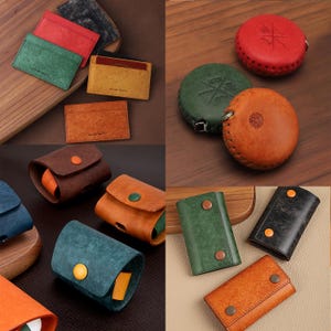 May include: Assortment of leather goods, including cardholders in red, green, and tan, along with key holders and round cases. The items are displayed on a wooden surface, showcasing various textures and colors.