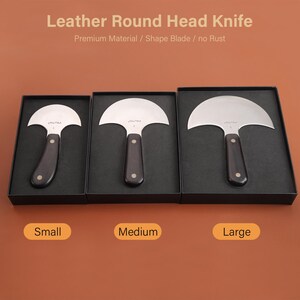 May include: Three leather round head knives in black boxes, labeled Small, Medium, and Large. Each knife has a curved, silver blade and a dark wooden handle. The text "Leather Round Head Knife" is at the top.