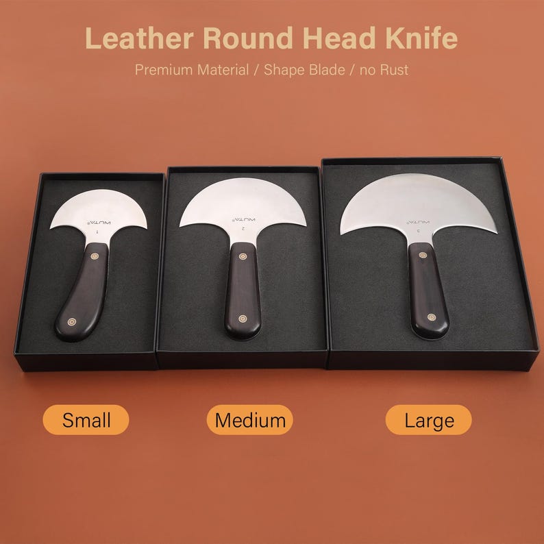 May include: Three leather round head knives in black boxes, labeled Small, Medium, and Large. Each knife has a curved, silver blade and a dark wooden handle. The text "Leather Round Head Knife" is at the top.
