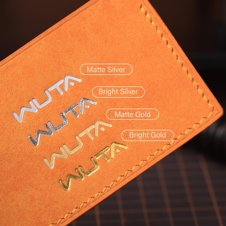 May include: Close-up of an orange leather product with the embossed brand name "WUTA" in silver and gold. The text "Matte Silver", "Bright Silver", "Matte Gold", and "Bright Gold" are also visible. The product has a stitched border.
