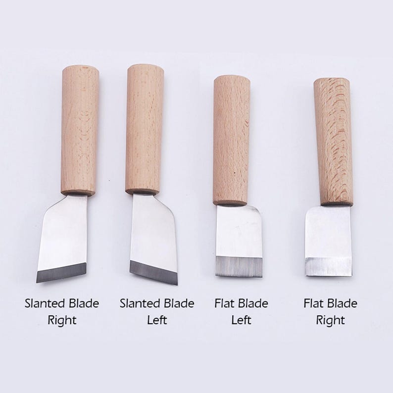 May include: Four leather craft tools with wooden handles. Two tools have a slanted blade, one with the blade angled to the right and the other to the left. The other two tools have a flat blade, one with the blade angled to the right and the other to the left.