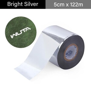 May include: Bright silver roll of material, 5cm x 122m, with a shiny, reflective surface. The roll is partially unrolled, revealing the inner core. A green circular patch with the word "WUTA" in white is in the upper left.