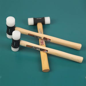 May include: Two rubber mallets with wooden handles. The mallets have white rubber heads and black rubber bands around the heads. The handles are made of natural wood.