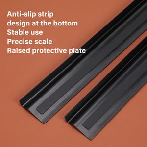 May include: Two black metal rulers with anti-slip strips on the bottom. The rulers have raised edges for protection. The text on the image reads: "Anti-slip strip design at the bottom Stable use Precise scale Raised protective plate"