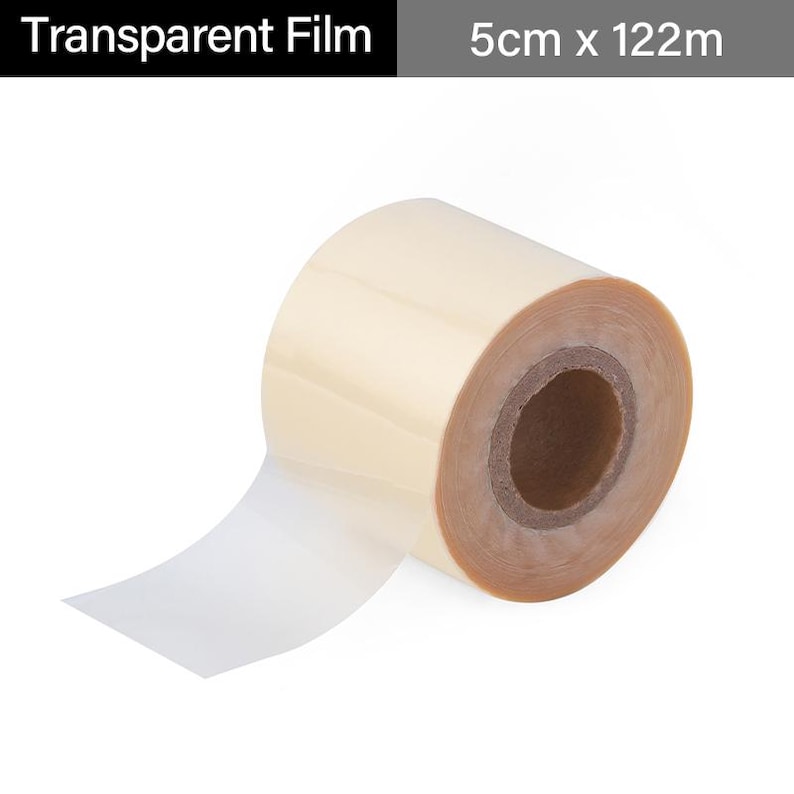 May include: A roll of transparent film with the text "Transparent Film" and dimensions of 5cm x 122m. The film is a light beige color and is partially unrolled, revealing a clear, adhesive-like surface.