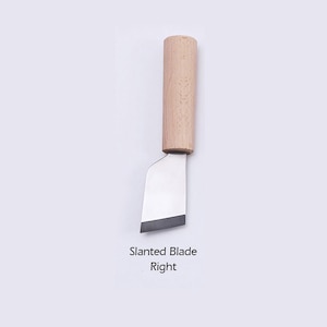 May include: A small, wooden-handled knife with a slanted blade. The blade is angled to the right. The text "Slanted Blade Right" is printed below the knife.