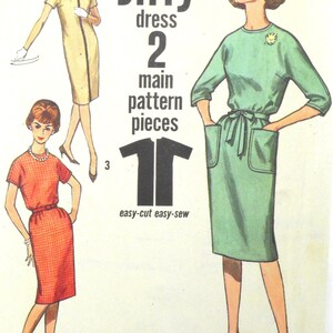 May include: Vintage sewing pattern illustration featuring three women modeling dresses. The text reads "Jiffy dress 2 main pattern pieces easy-cut easy-sew." Dresses are in yellow, red, and green.