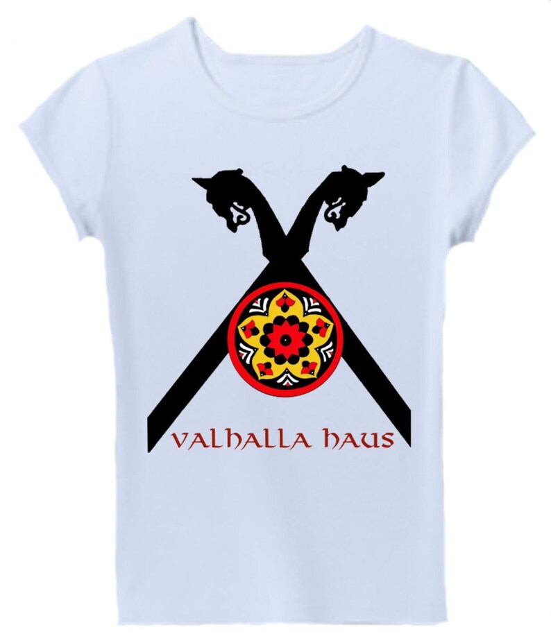 May include: White t-shirt with a black and red design of two crossed Viking ship prows with a yellow and red circular design in the center. The text "VALHALLA HAUS" is printed in red below the design.