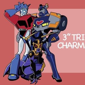 May include: Illustration of three cartoon robot characters in blue, red, and yellow. The text "3" TRIO CHARMS !!" is displayed in white. The characters are posed against a red background.