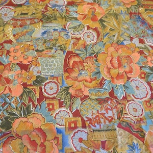 May include: A red fabric with a repeating pattern of gold, blue, and green floral designs. The fabric features stylized vases and flowers.