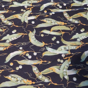 May include: A black fabric with a repeating pattern of green pea pods and vines. The pea pods are filled with small white peas.