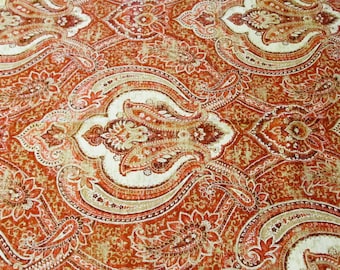 May include: Red, white, and brown paisley patterned fabric with a vintage look.