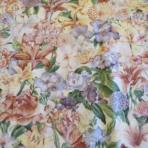 May include: A white fabric with a floral pattern featuring a variety of flowers in shades of pink, red, yellow, blue, and green. The flowers are arranged in a random pattern and are surrounded by green leaves.