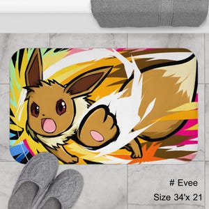 May include: A rectangular bath mat featuring a cartoon Eevee character with a dynamic action pose against a vibrant yellow and orange background. The mat measures 34 inches by 21 inches and includes the text "# Eevee".