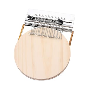 May include: A wooden circular base with a metal frame and hooks for hanging clothes. The frame is made of stainless steel and has a brushed finish.