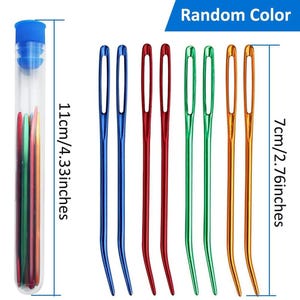May include: A set of eight bent-tip tapestry needles in blue, red, green, and orange, with a clear storage tube featuring a blue cap. The needles measure 2.76 inches in length, and the storage tube measures 4.33 inches in length.