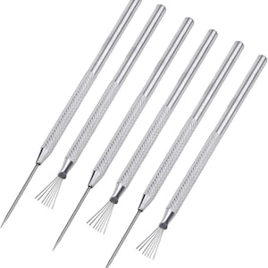 May include: Set of six silver-colored metal coil cleaning tools. Each tool has a textured handle and a thin, pointed end with a fan-shaped brush. The tools are designed for cleaning air conditioner coils and other similar applications.