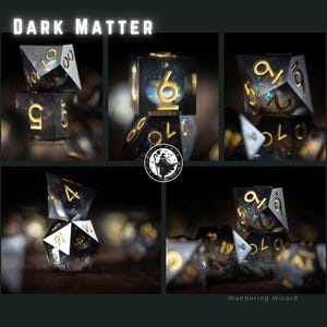 May include: A selection of polyhedral dice with a dark, space-themed design. The dice are black with gold numbering and internal glitter, and the text "DARK MATTER" is at the top. The image also includes the logo for "Wandering Wizard".