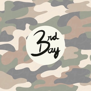 May include: Camouflage pattern in shades of green, brown, and gray. A white circle in the center features the text "3rd Day" in black script.