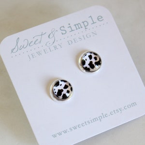 Cow print glass dome post earrings.  Silver setting.  Small black and white cow pattern studs. 8mm.