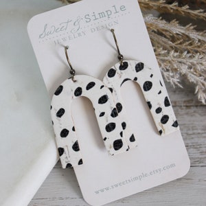 U shaped cork on leather earrings | White and black dalmatian print | Weathered cork pattern | Spotted print