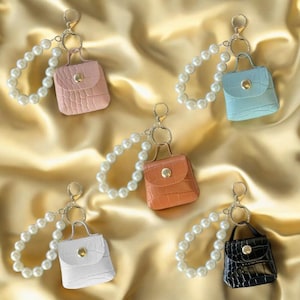 Mini billetera con llavero de perla para guardar auriculares, accesorio compacto para regalo de mujer