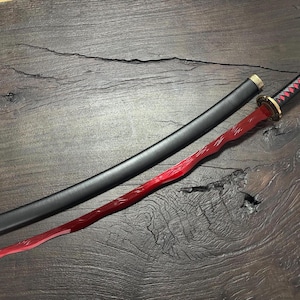 May include: A red and black katana sword with a black scabbard. The sword features a red blade with a unique wavy design. The handle is black with red accents, and the scabbard is black with gold details.