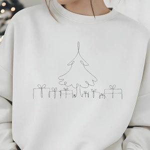 Könnte beinhalten: Ein weißer Pullover mit einer einfachen Linienzeichnung eines Weihnachtsbaums und Geschenken.