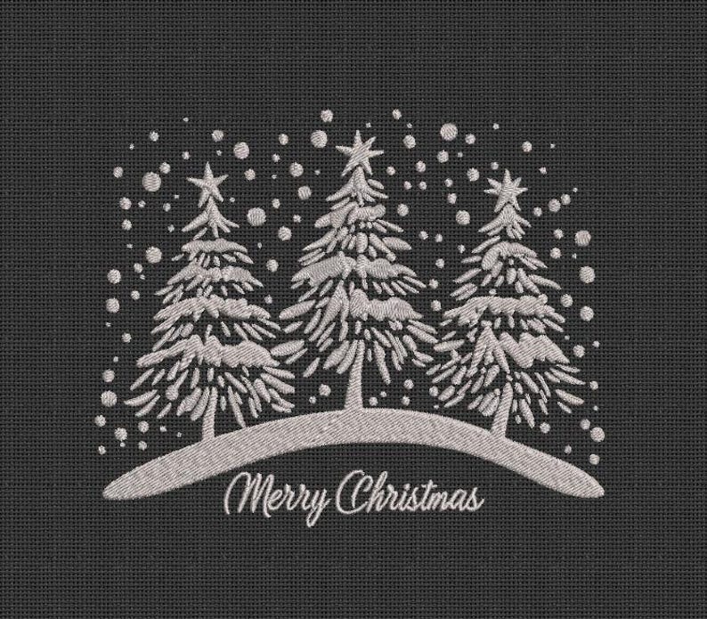 May include: Embroidered design of three white snow-covered trees with a snowy hill and the text "Merry Christmas" on a black background.