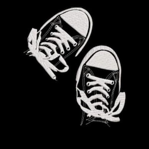 May include: An embroidered design of two black and white sneakers with white laces, set against a black background. The sneakers are depicted from a top-down perspective, with the laces appearing loose and flowing.